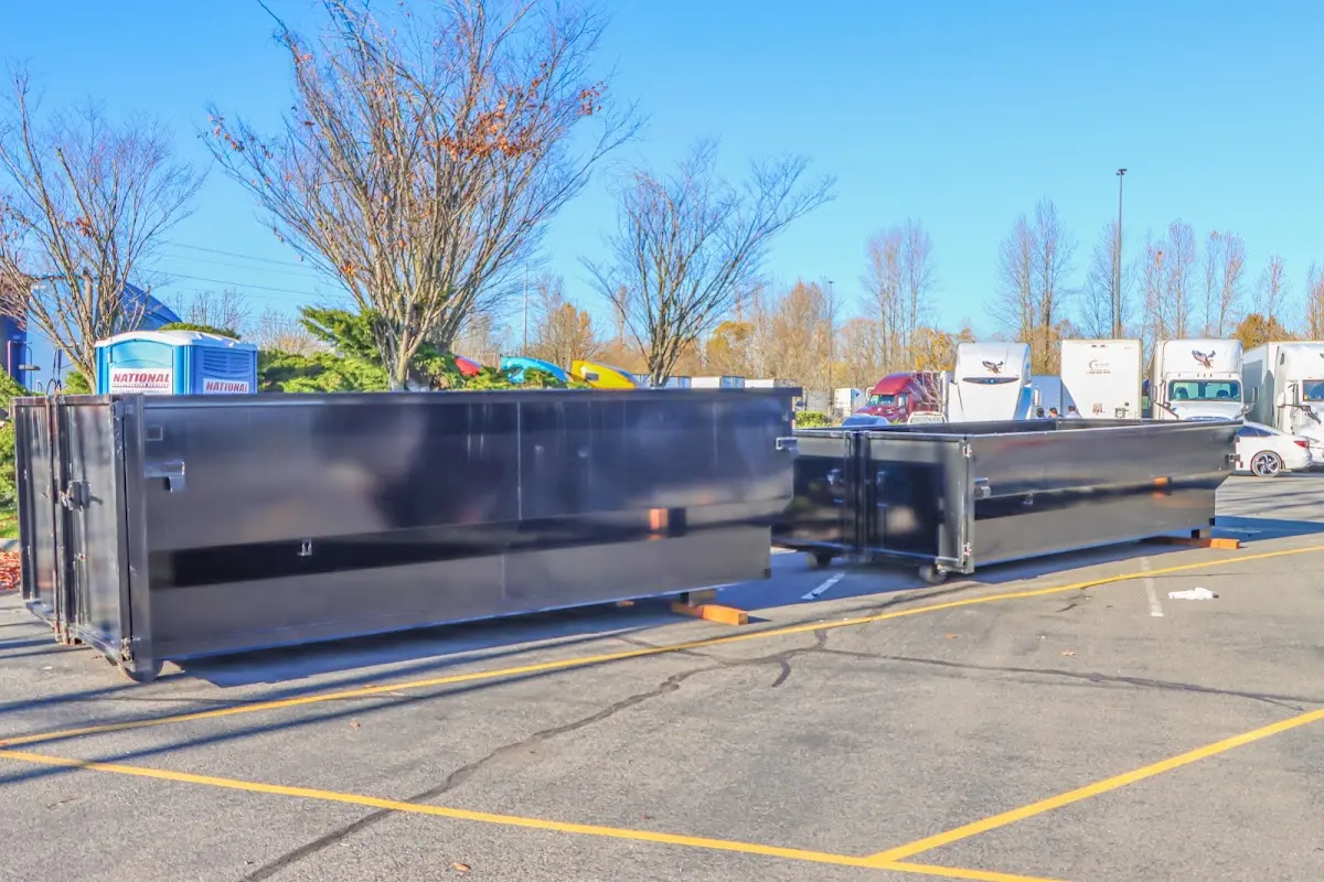 Professional dumpster rental service with roll-off container on residential driveway in St. Louis Park